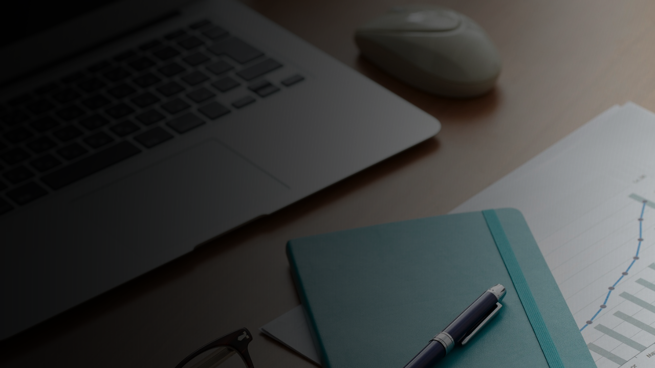 Notebook and laptop on desk