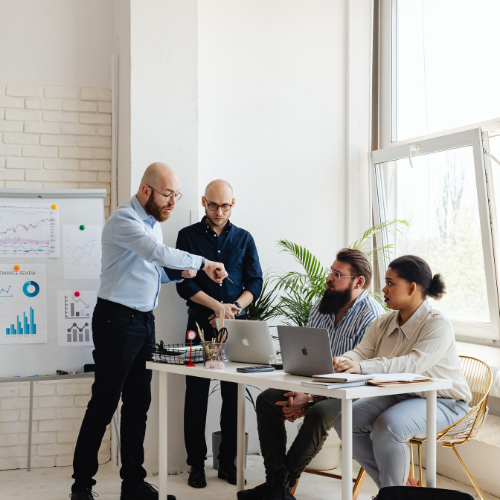 Colleagues sat at desk brainstorming