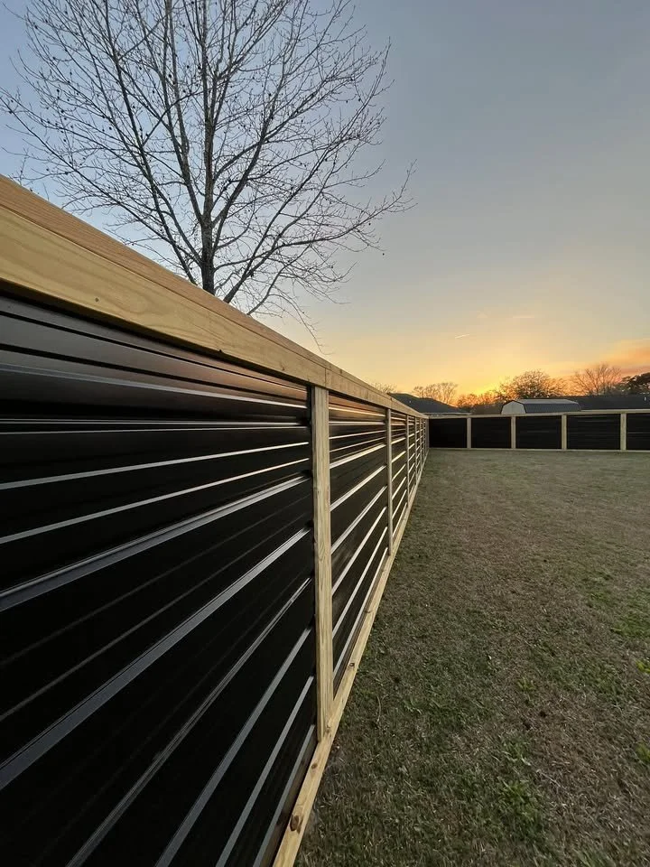 Custom Black corrugated metal privacy fence built by Johnson Family Construction