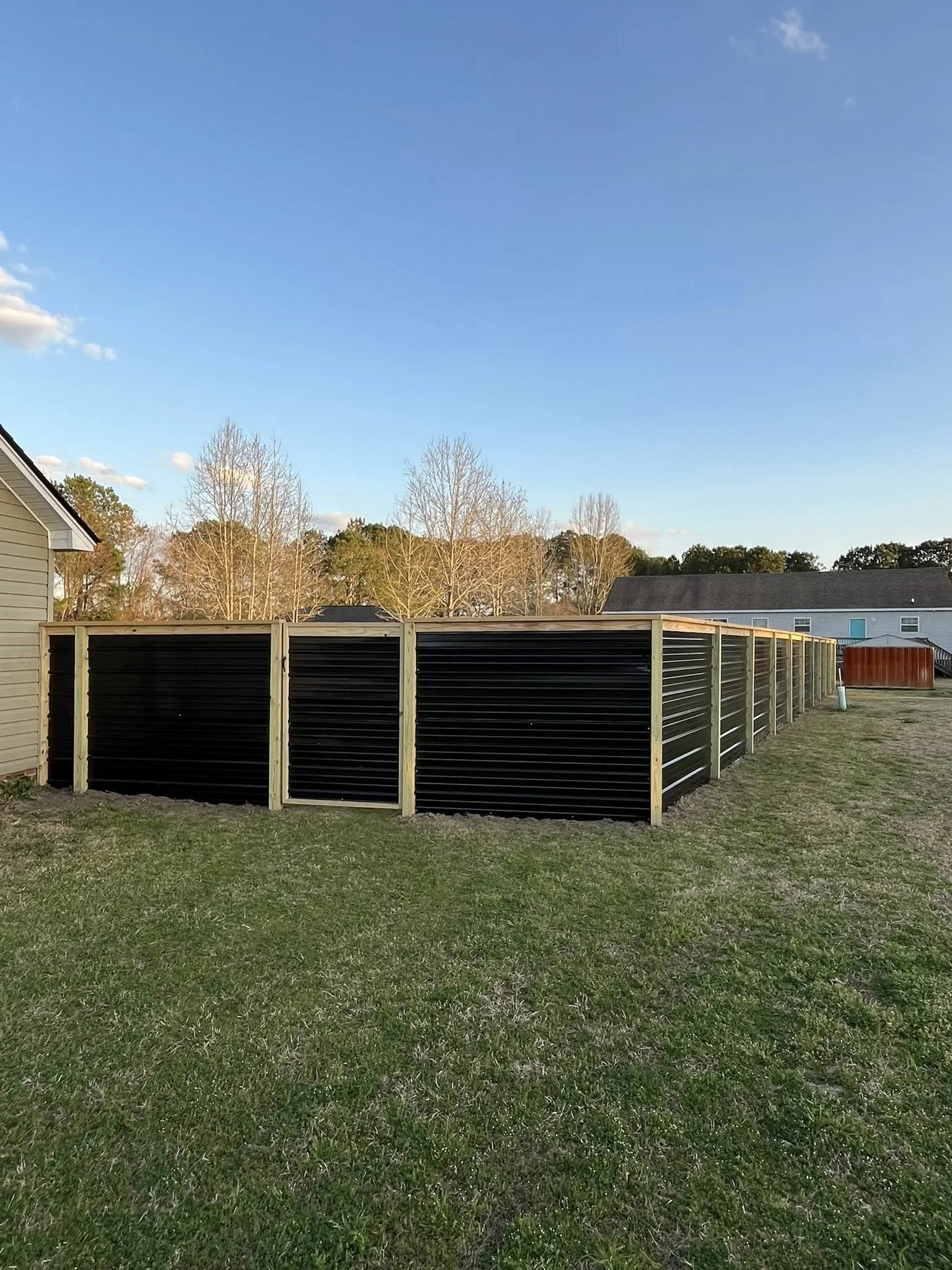 Custom Black corrugated metal privacy single gate built by Johnson Family Construction