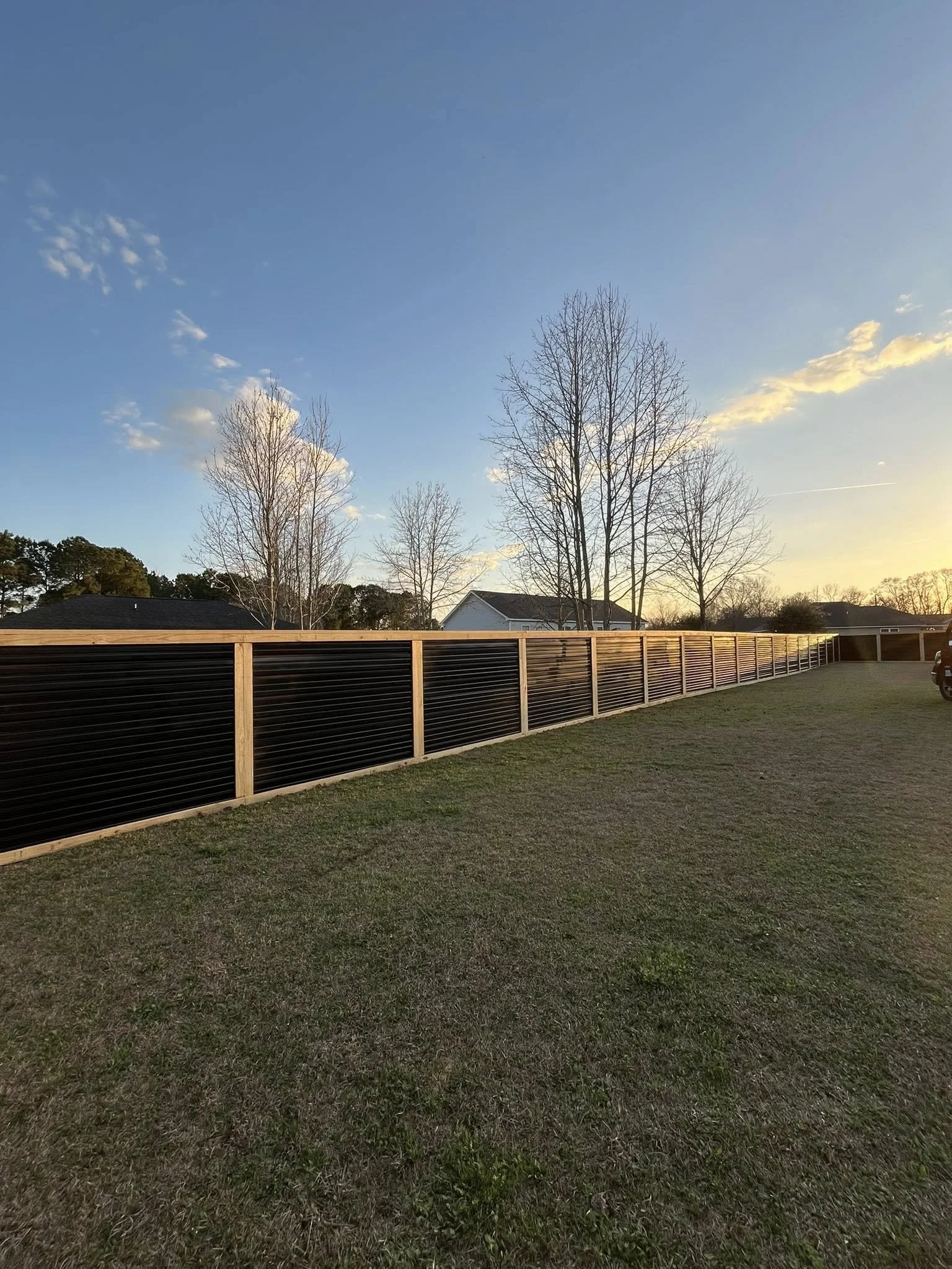 Custom Black corrugated metal privacy fence built by Johnson Family Construction