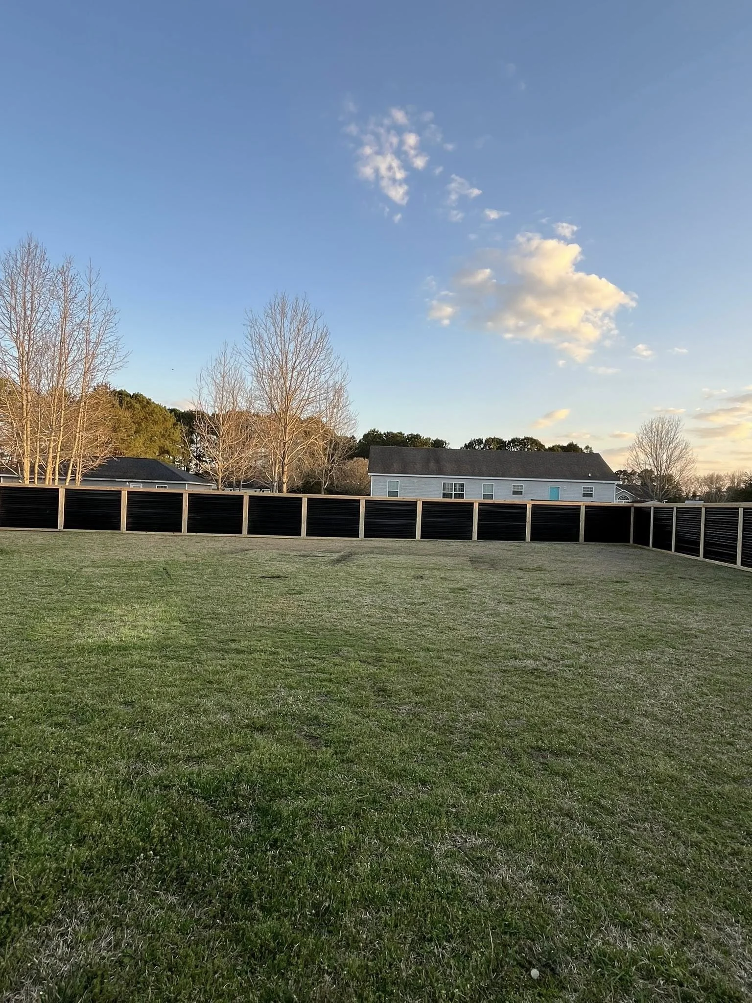 Custom Black corrugated metal privacy fence built by Johnson Family Construction