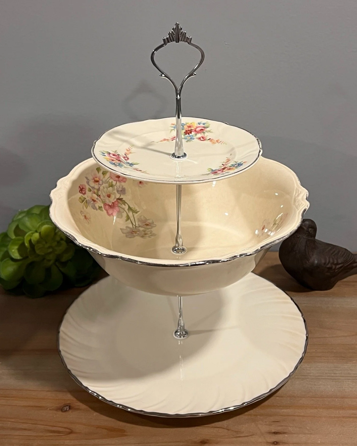 This is what happens when you combine three beautiful vintage pieces ... Taylor, Smith &amp; Taylor on top, Homer Laughlin in the middle and a LENOX piece on the bottom. Unique shape. Lots of possibility.

https://www.mockingbirdheirloomco.com/shop/p