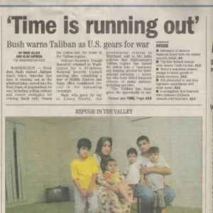 A newspaper article with the headline 'Time is running out' and a photo of a group of six people, including four children and two adults, sitting on a couch in a room with light-colored walls.
