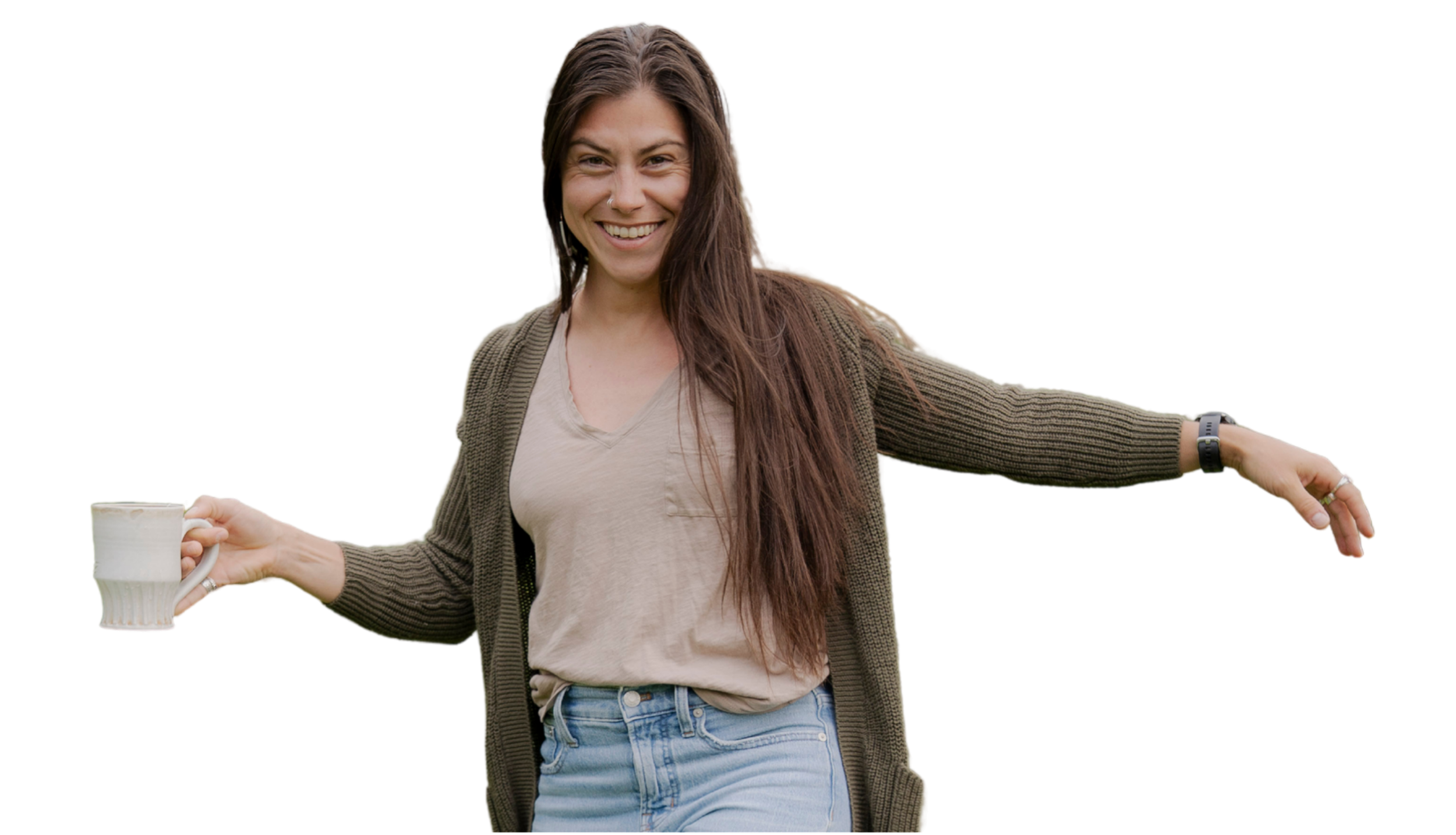 A smiling woman with long brown hair holding a mug in one hand and spreading her arms out.