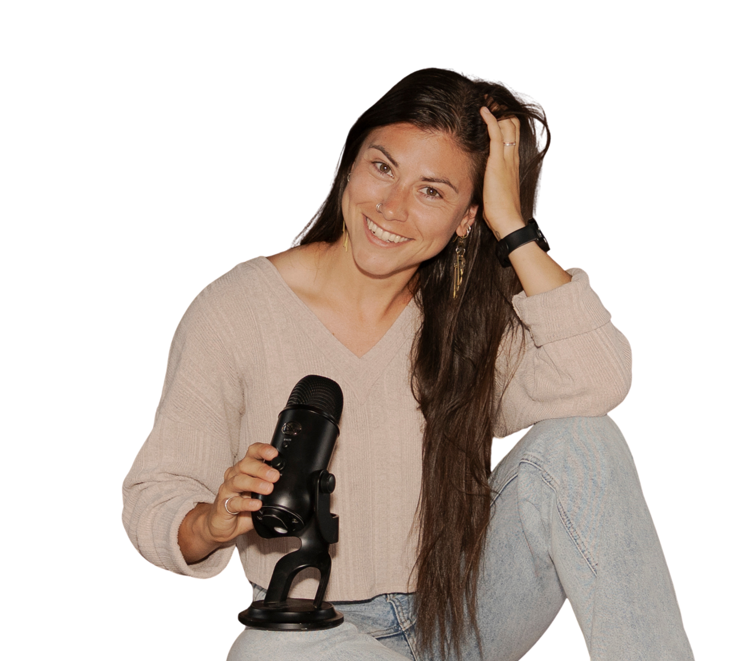 A woman with long dark hair, light skin, and a nose ring smiling while holding a black microscope.