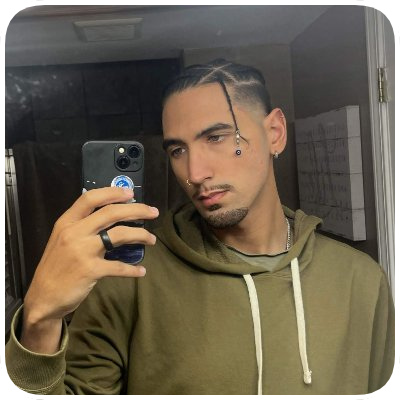 Young man taking a mirror selfie with a smartphone, wearing an olive green hoodie, with a side part hairstyle and facial piercings.
