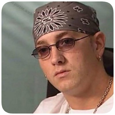 Person wearing glasses, a bandana, and earrings, with a serious expression.