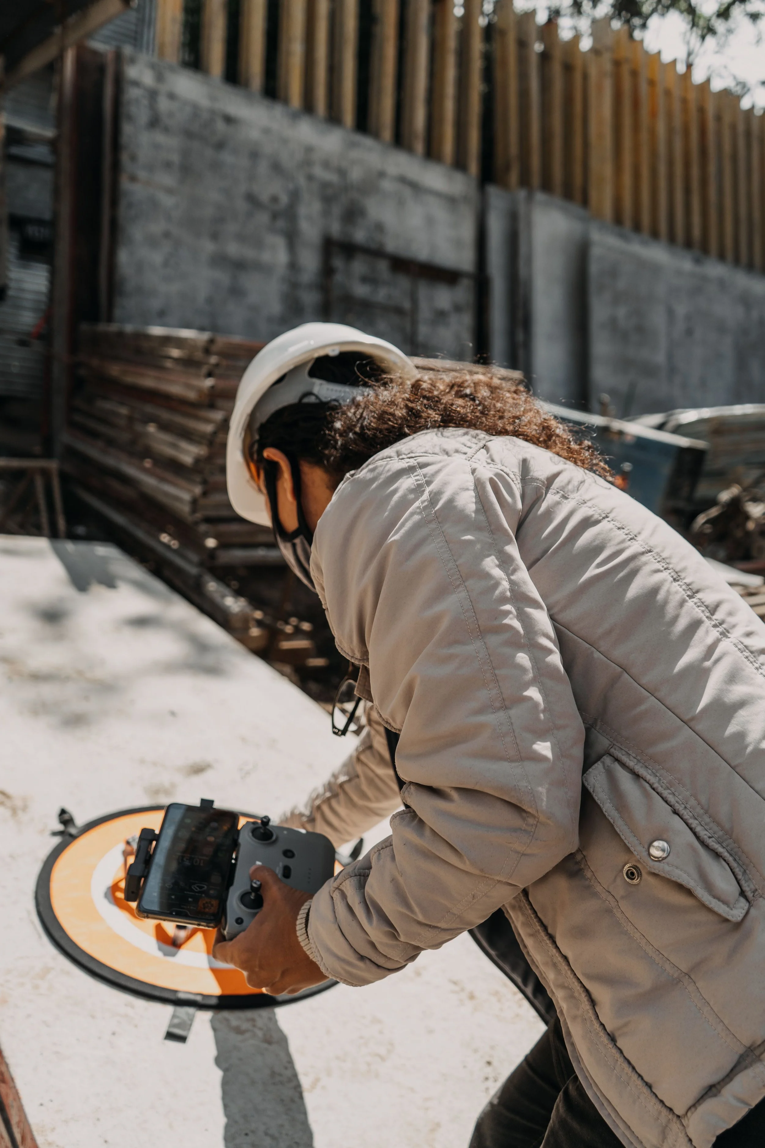 Drone operator using a controller at a construction site