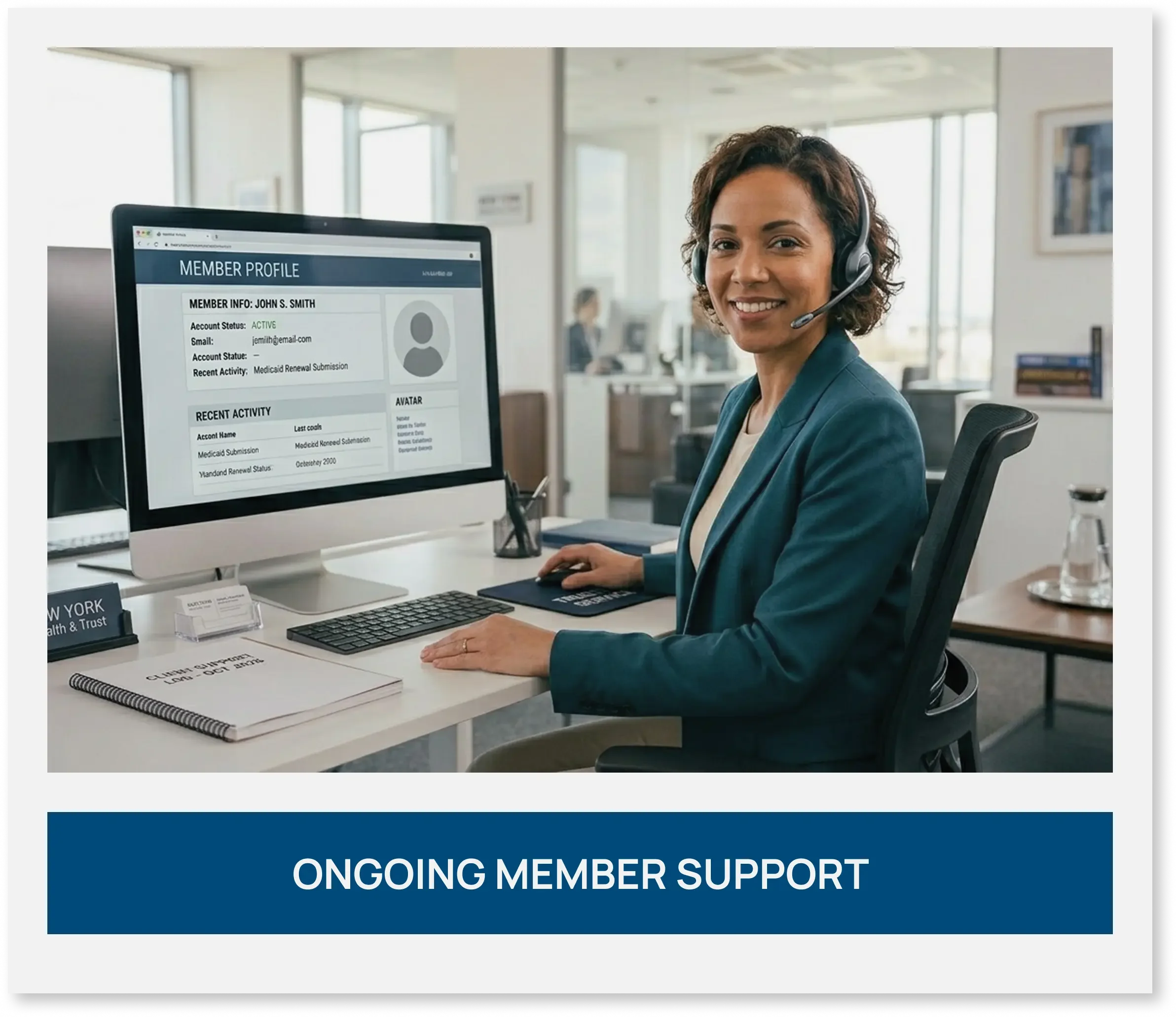 Support specialist wearing a headset and smiling while working at a computer desk.