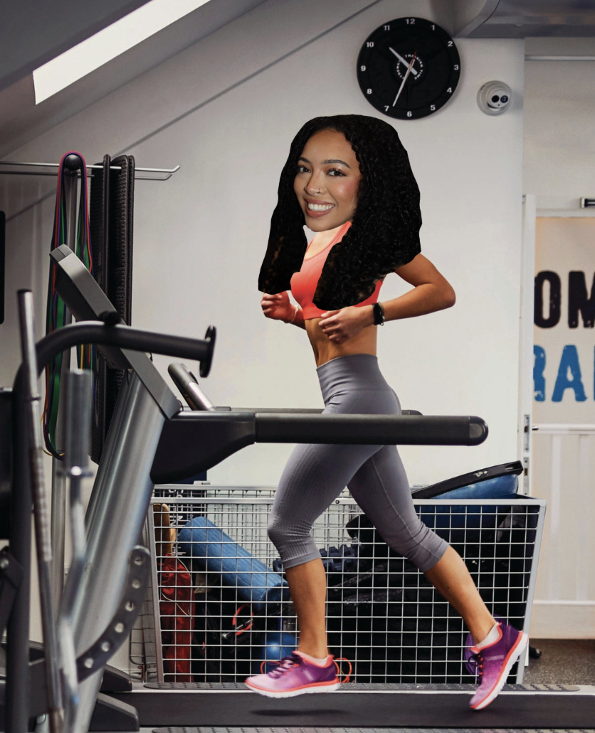 A woman with curly hair smiling while running on a treadmill in a gym