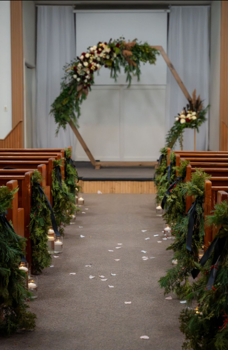 church aisle winter green swags and lush arch
