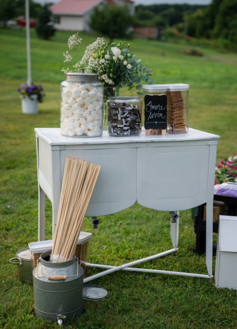 reception decor smore bar with flower arrangement