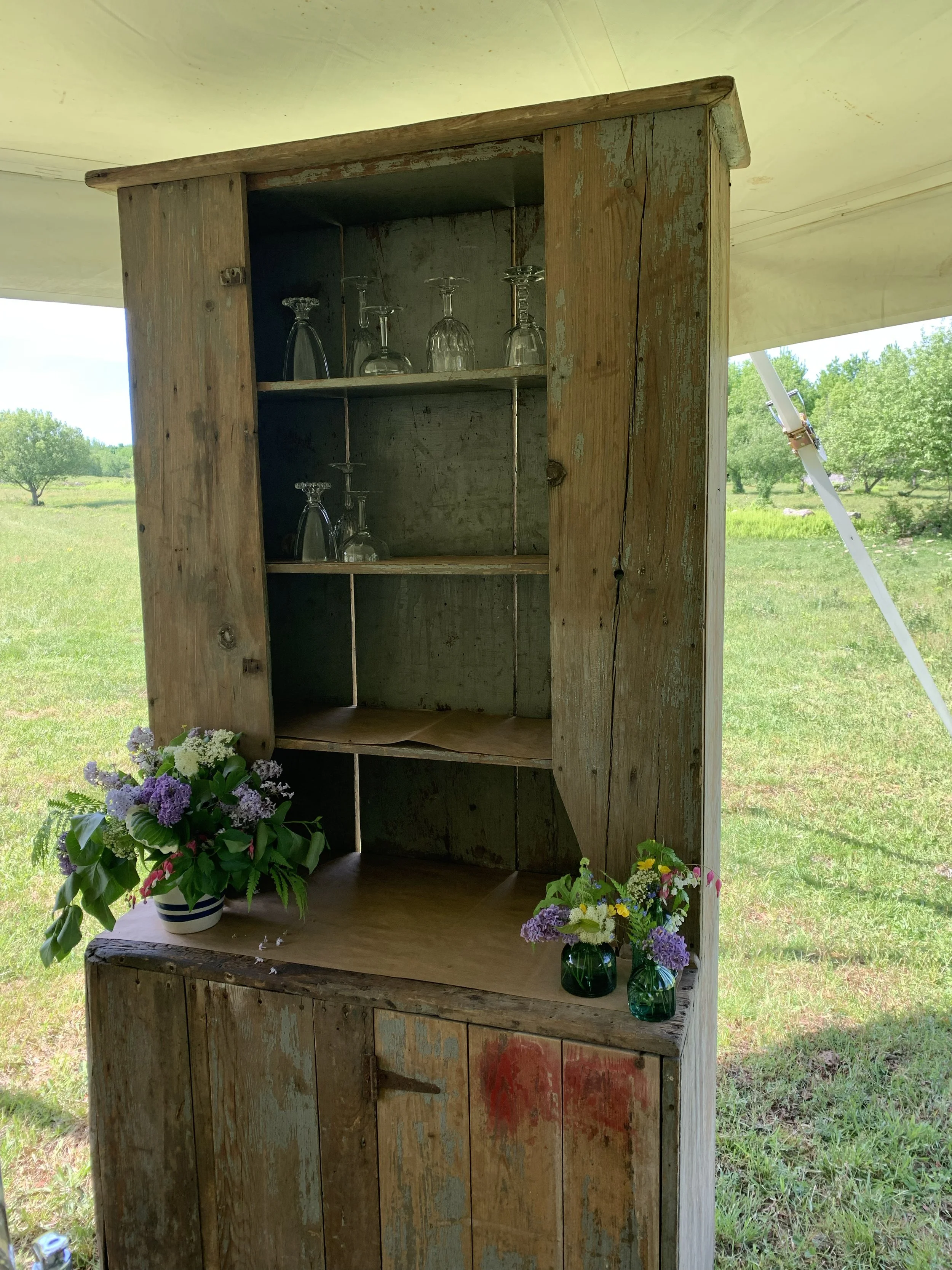 flower arrangements on antique hutch