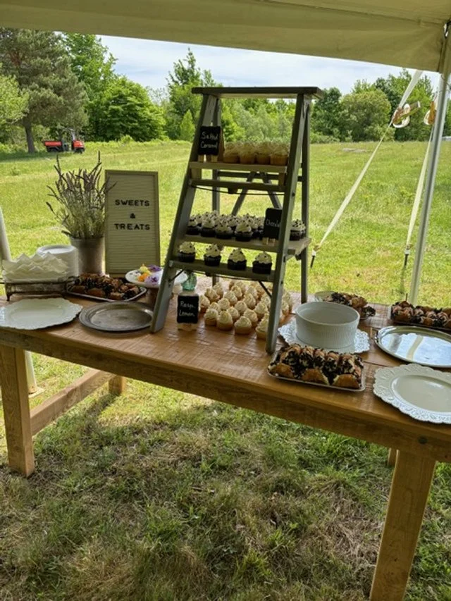 cupcake and desert display with ladder and floral arrangement