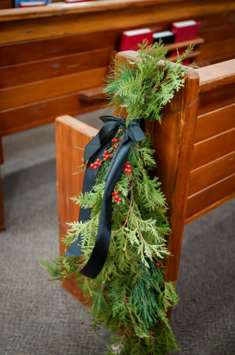 pew swag winter greenery and black satin bow