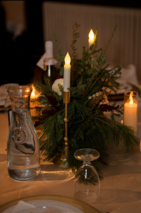 table centerpieces with candles and winter greenery