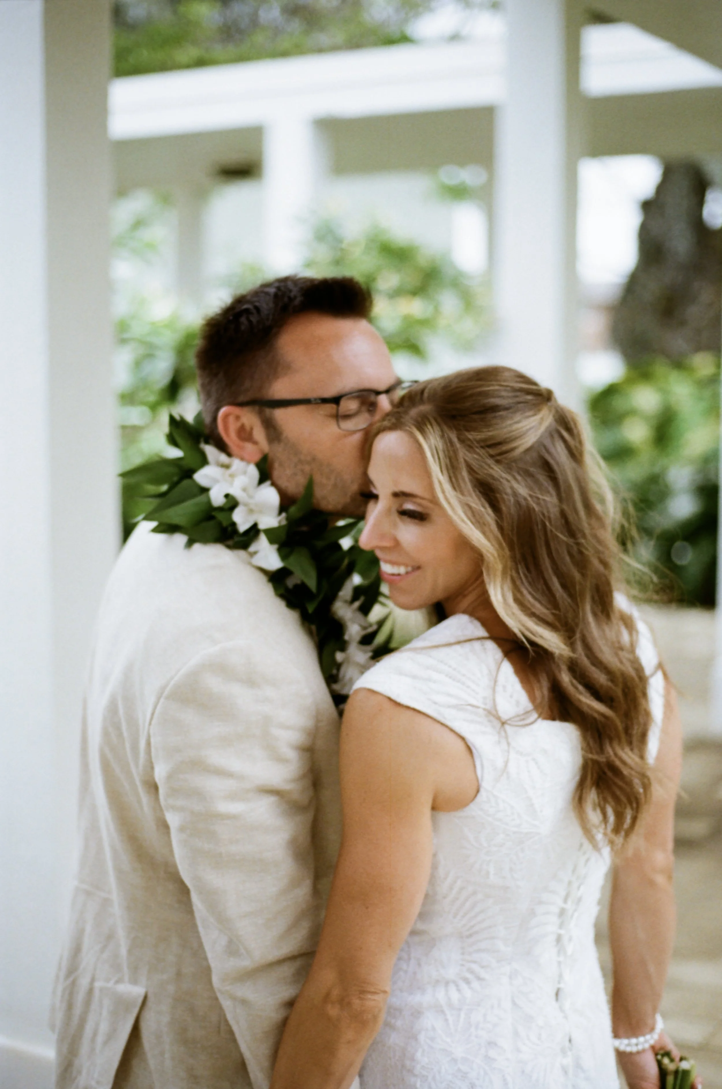 Couple intimate wedding portrait shot on 35mm film in Oahu Hawaii.