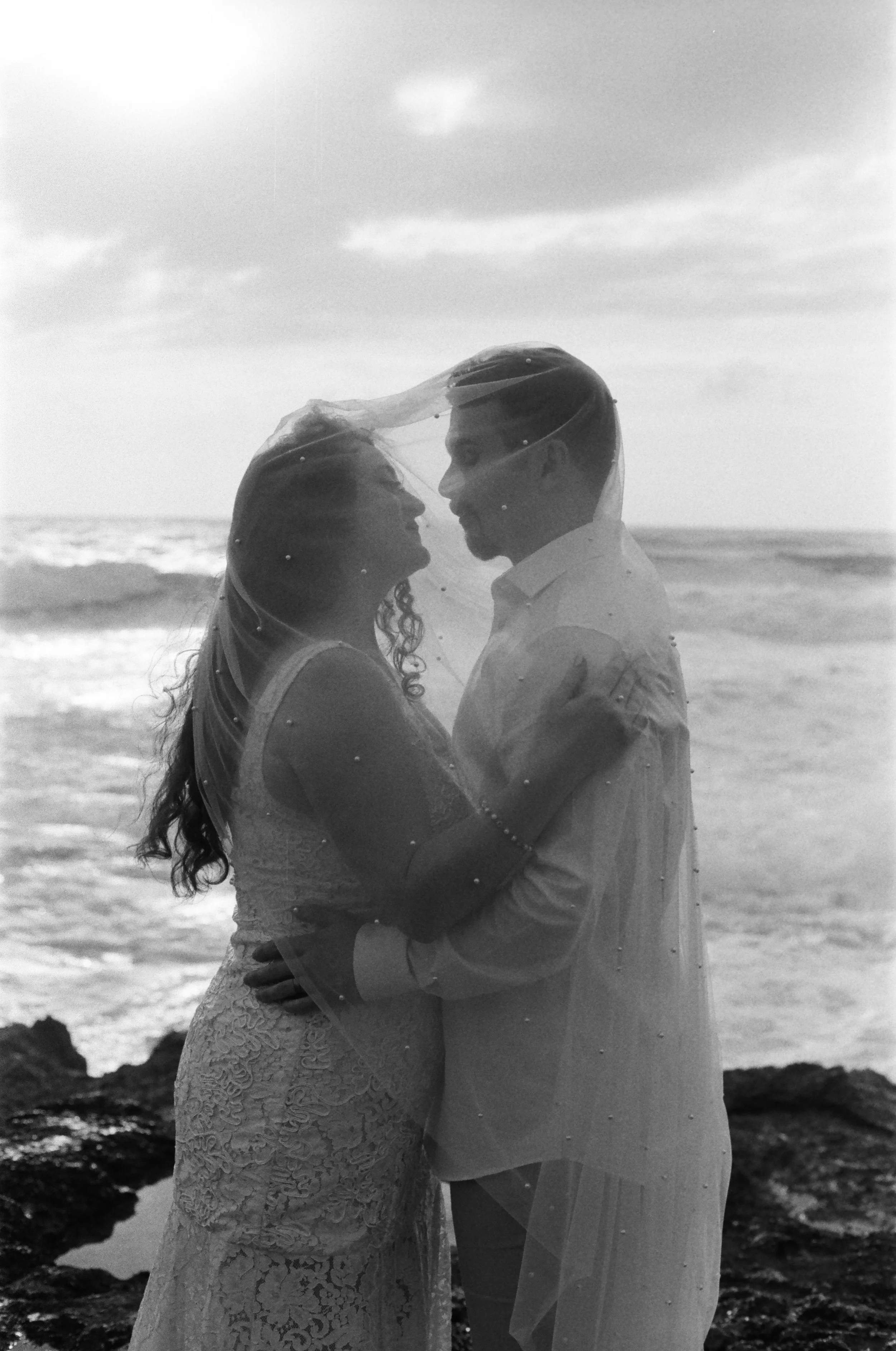 Couple intimate wedding portrait shot on 35mm film in Oahu Hawaii.