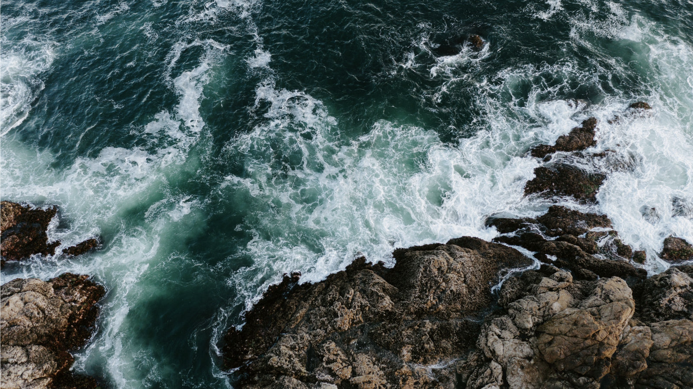 Photograph print of ocean waves crashing against a rocky shoreline.