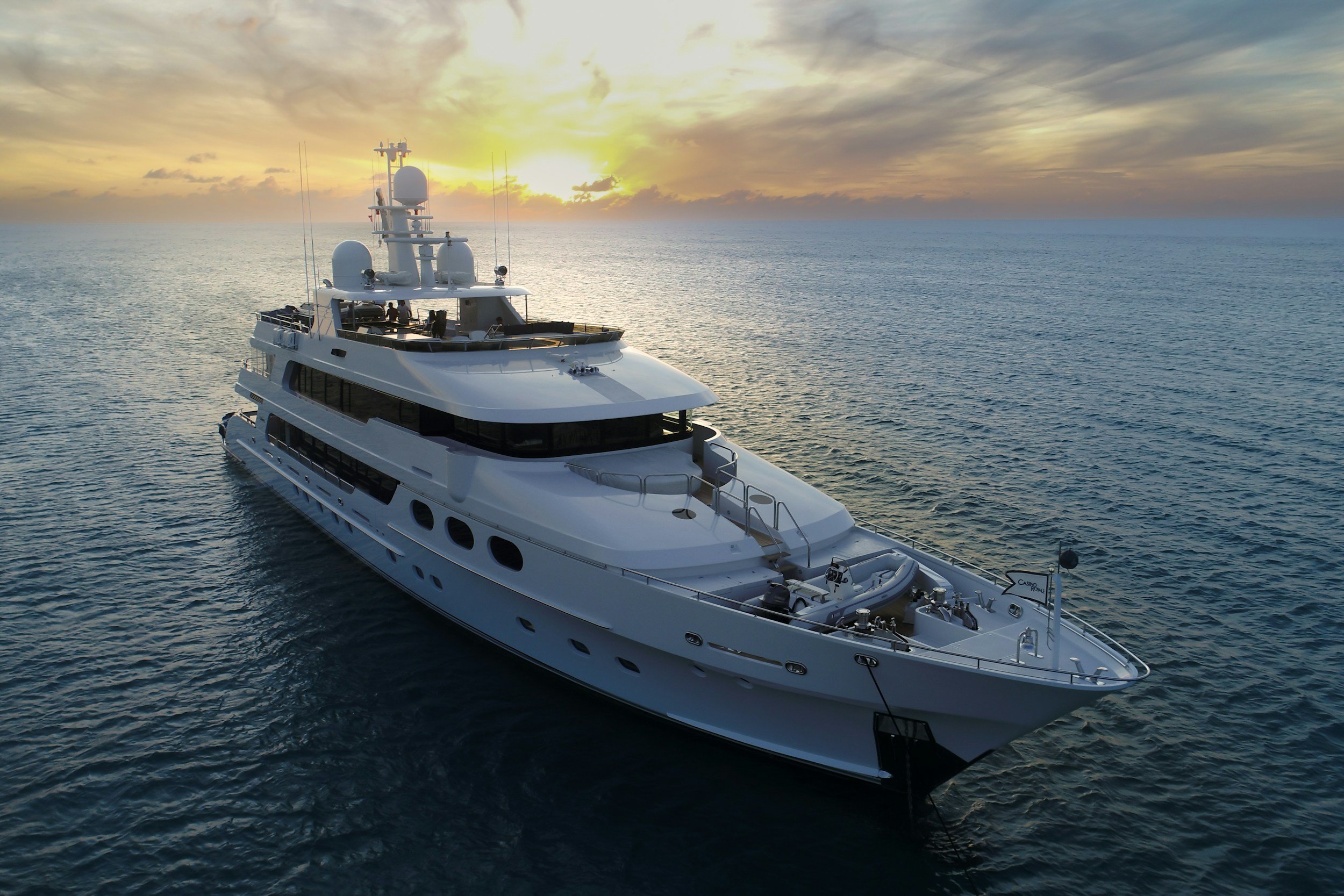 Mega yacht, super yacht, yacht underway with sun setting