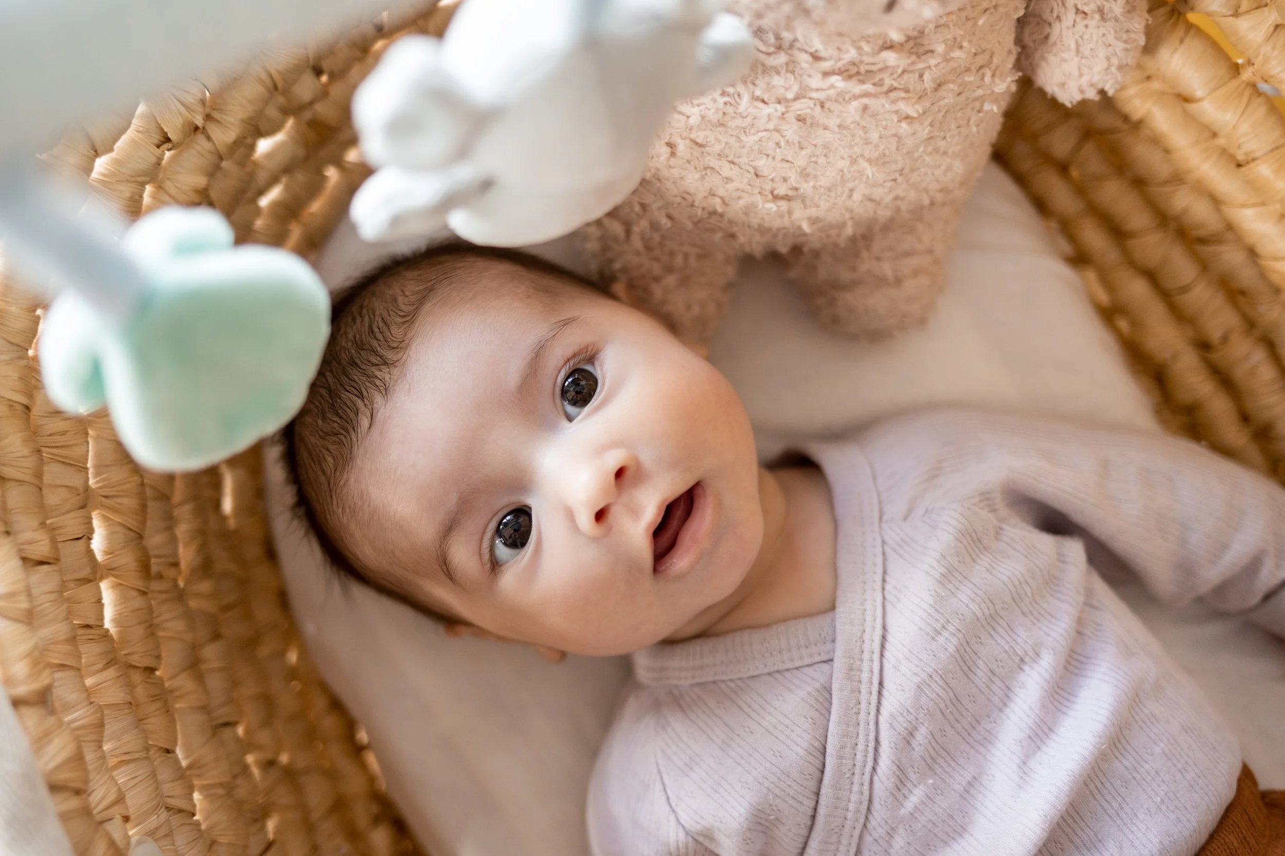Cute little baby boy with big eyes looking at mother