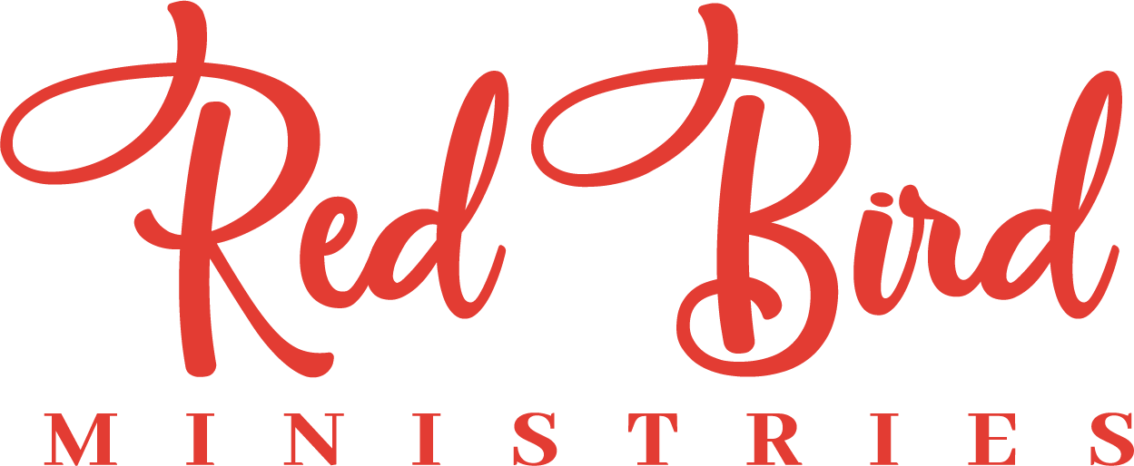 Red Bird Ministries logo with stylized red script text 'Red Bird' and smaller uppercase letters 'MINISTRIES' below.