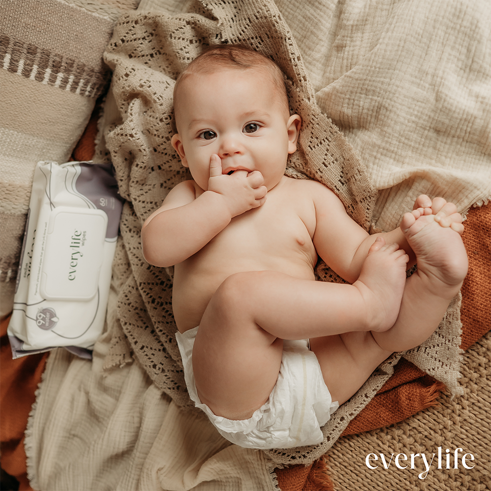 EveryLife baby wearing a diaper next to baby wipes
