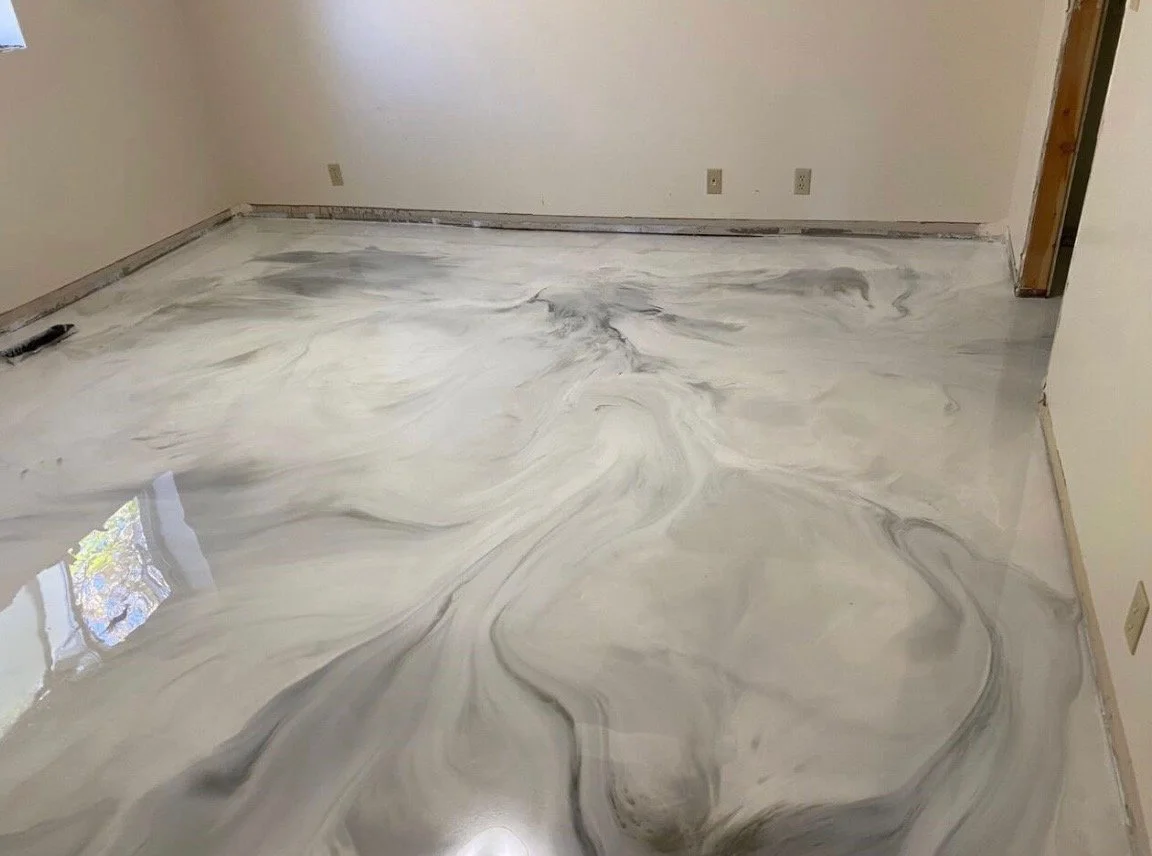 Polished marble or similar stone floor with swirling gray, black, and white patterns in an empty room.
