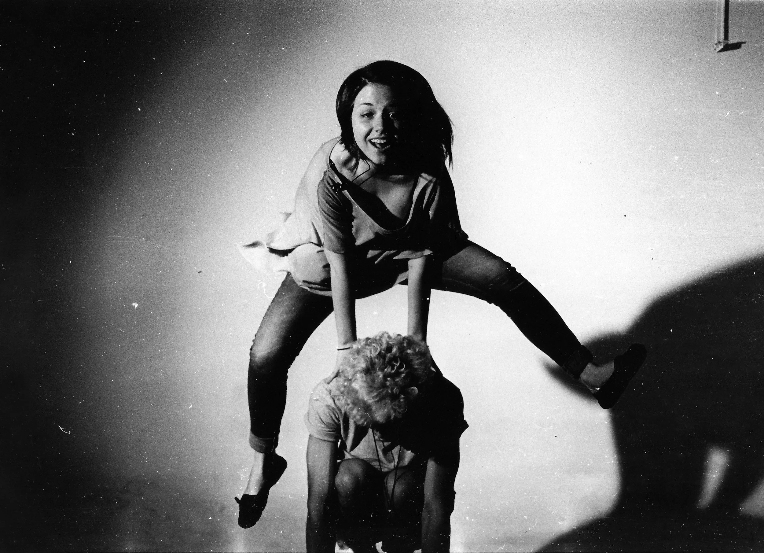 Two people playing leapfrog.