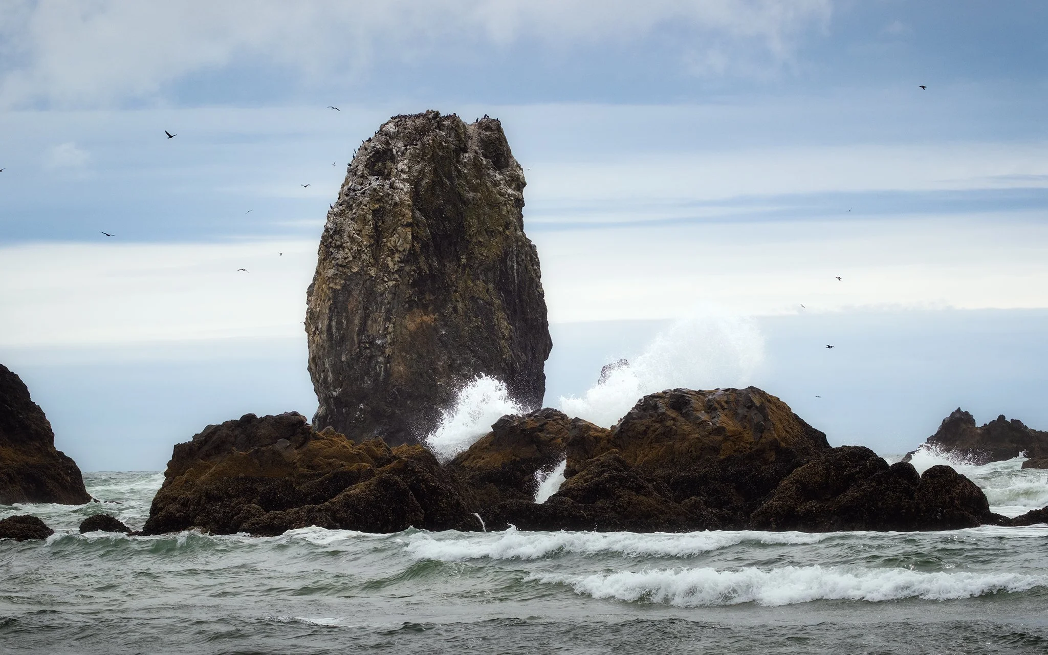 Waves crashing against sea stacks at Cannon Beach