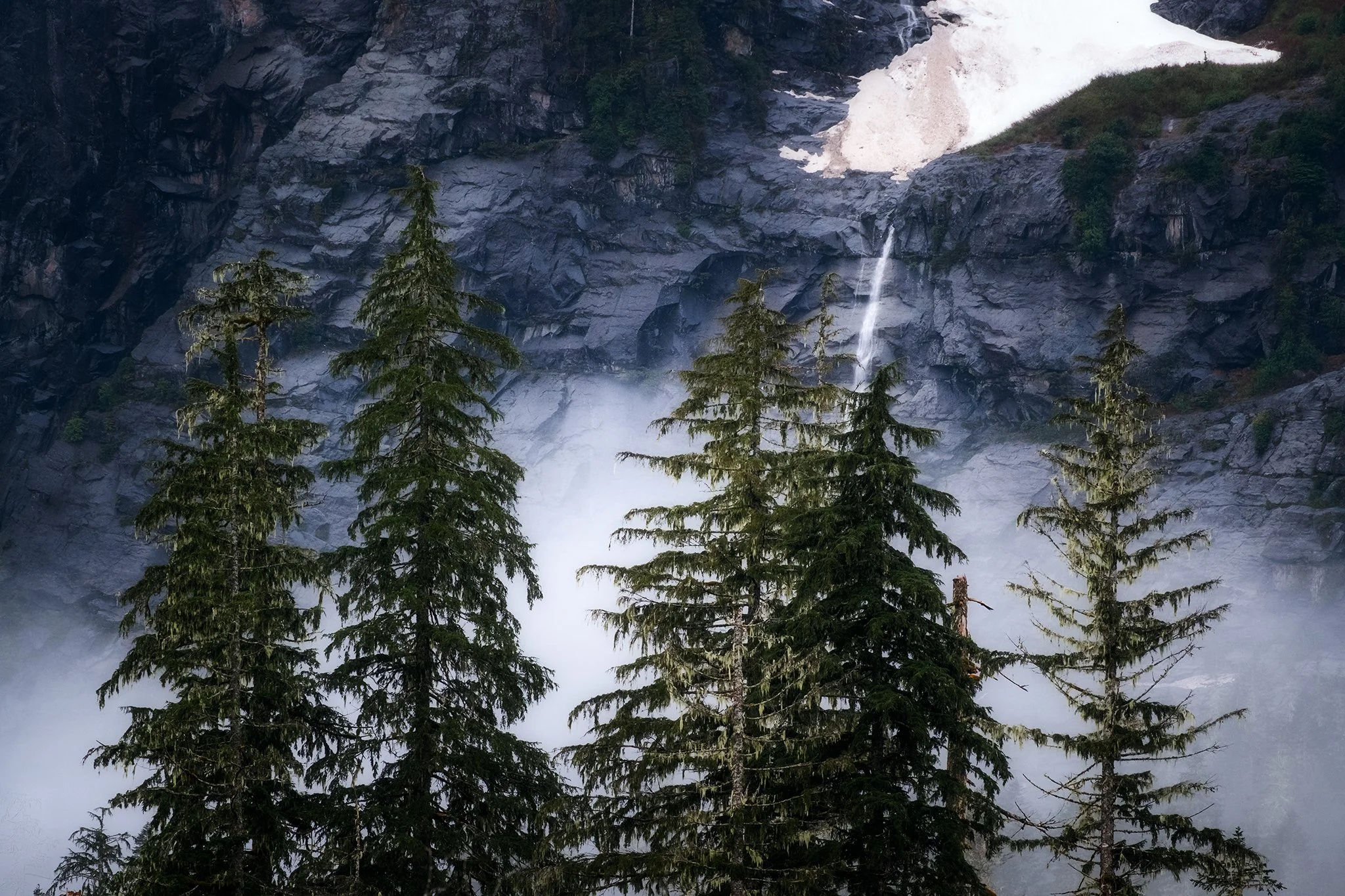 Glacial waterfall cascading into the mist at Big Four Mountain