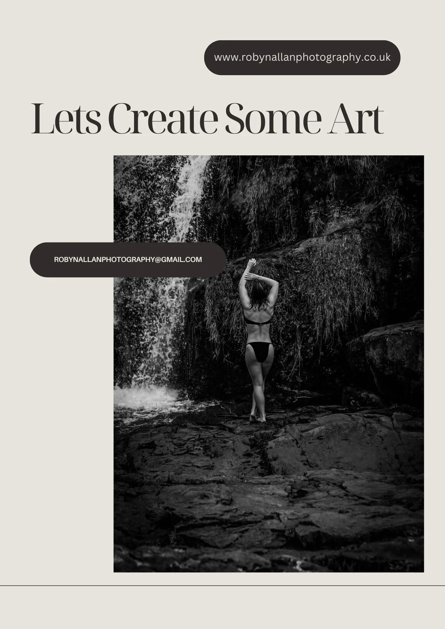 A black and white photo of a woman standing near a waterfall with her back to the camera, wearing a bikini, and raising her arms above her head.