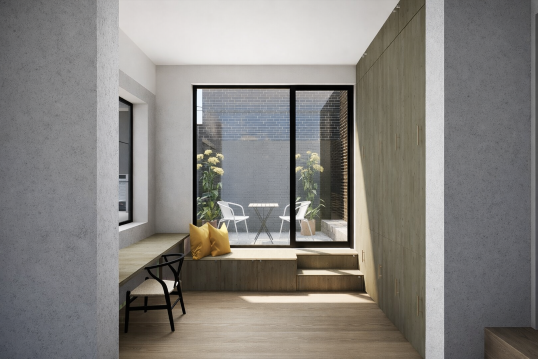 Minimalist interior room with large sliding glass doors leading to a small outdoor patio with chairs and plants.