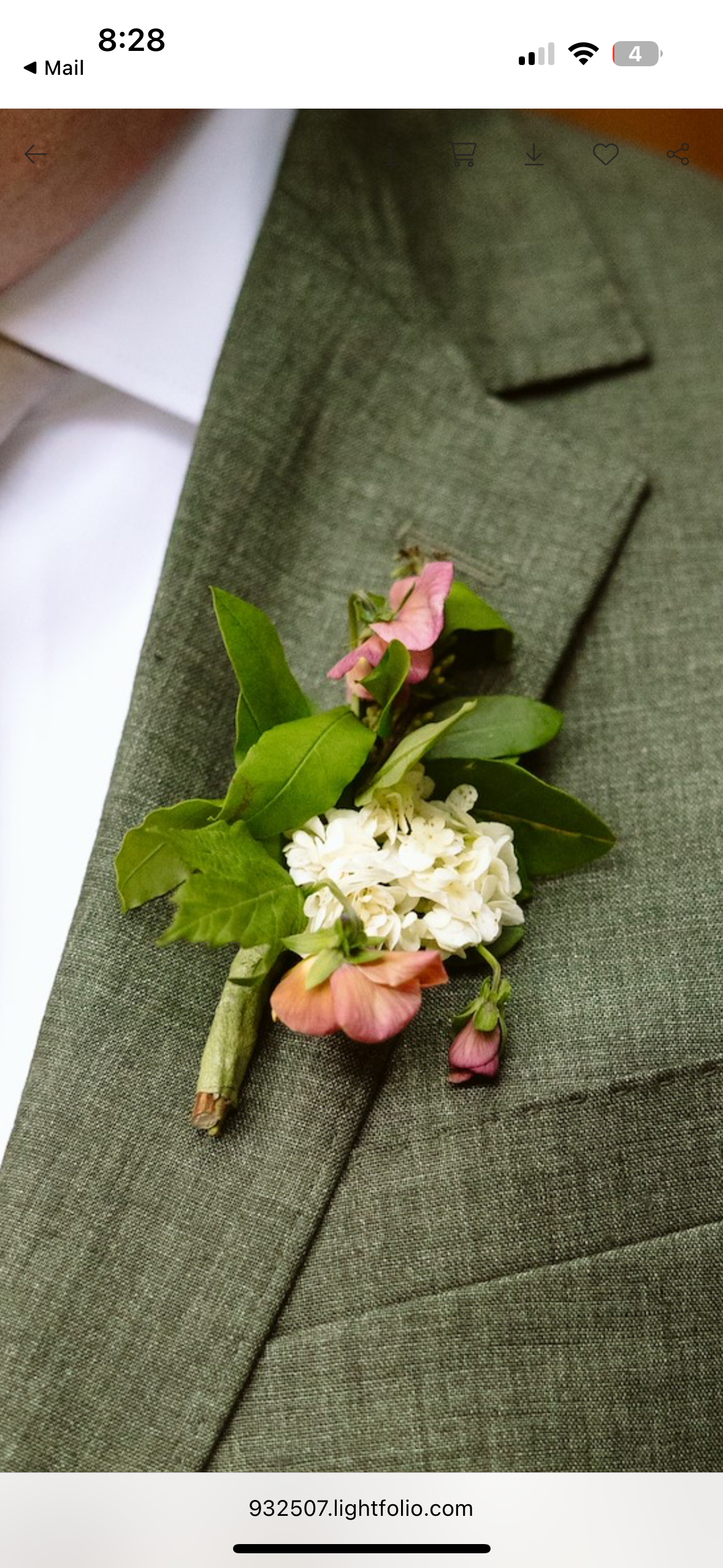 A boutonniere made of white flowers, pink flowers, and green leaves is pinned to a green textured suit jacket worn over a white shirt. marigolds florals nyc florist wedding florals houston hall nyc bar wedding