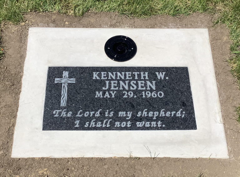 Grave marker for Kenneth W. Jensen, born May 29, 1960. The marker features a cross and a Bible verse, "The Lord is my shepherd; I shall not want."
