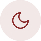 Close-up of a dark red, circular object with a faint crescent-shaped mark in the center.