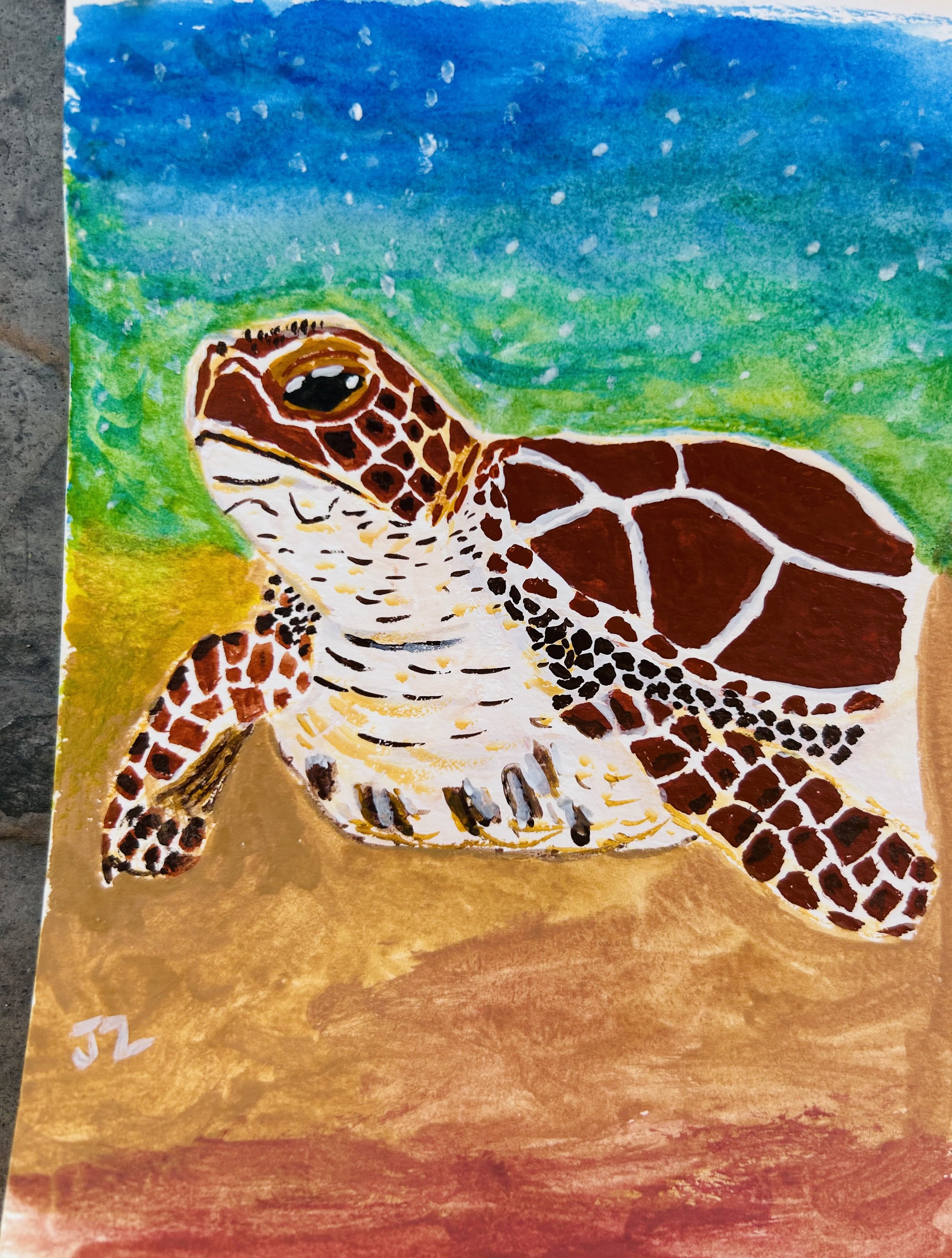 Watercolor painting of a sea turtle on sand with blue sky background.