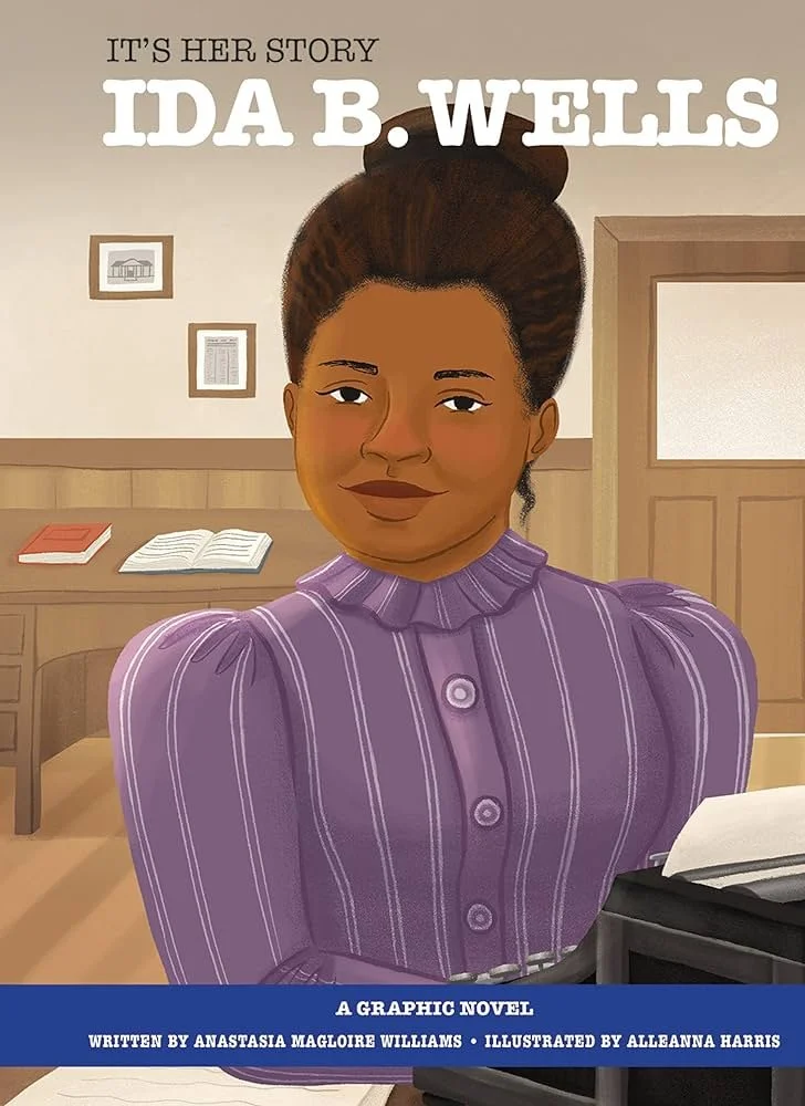 The cover of the graphic novel, It's Her Story: Ida B. Wells, written by Anastasia Magloire Williams and illustrated by Alleanna Harris. Ida B. Wells sits behind her typewriter, smiling.