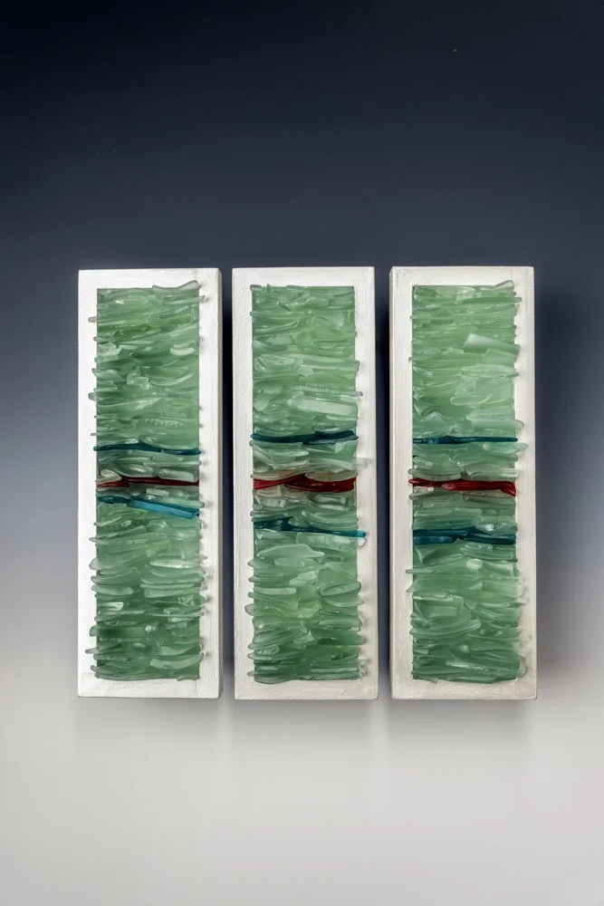 Upcycled alcohol bottles from Puerto Rico made into wall art