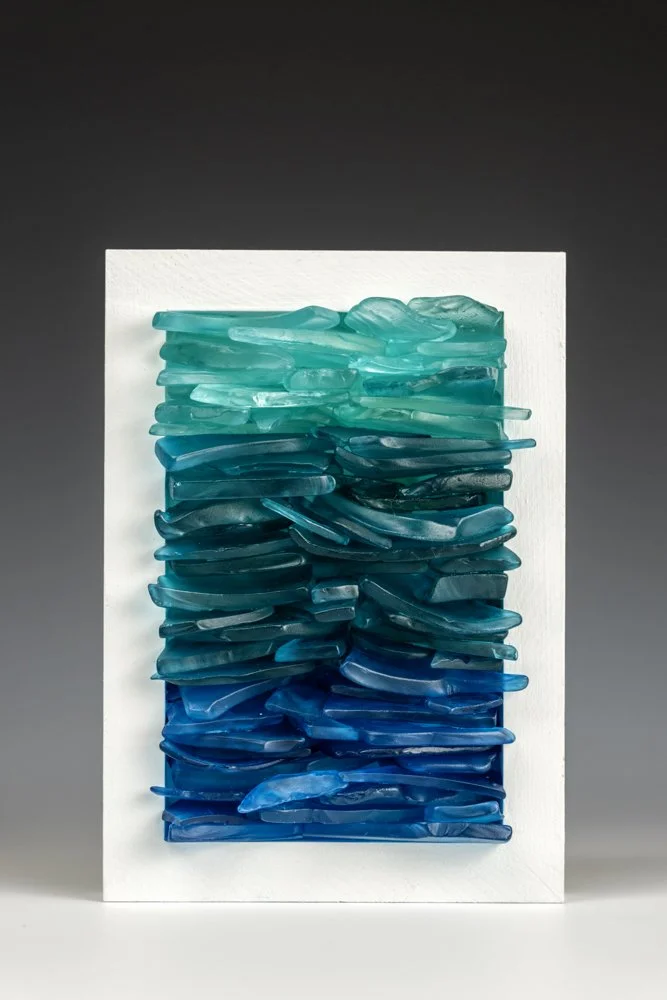 Upcycled spirit and wine bottles hand dyed and turned into a wall hanging made in Puerto Rico