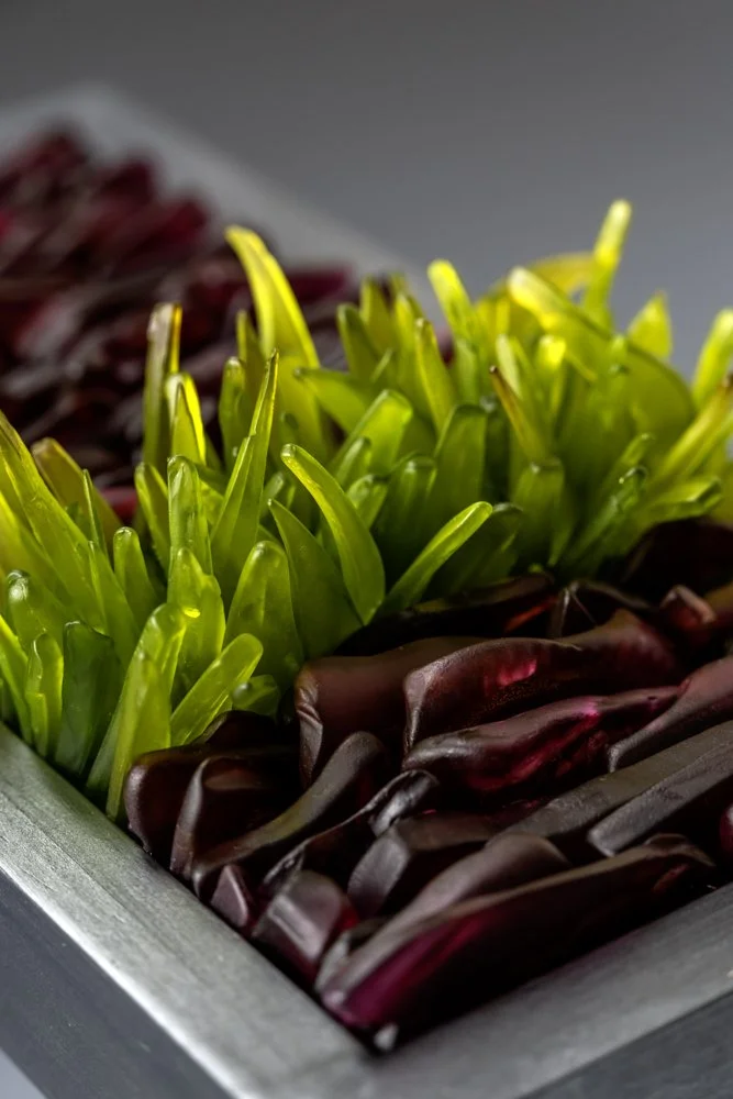 Upcycled spirit and wine bottles hand dyed and turned into a wall hanging made in Puerto Rico