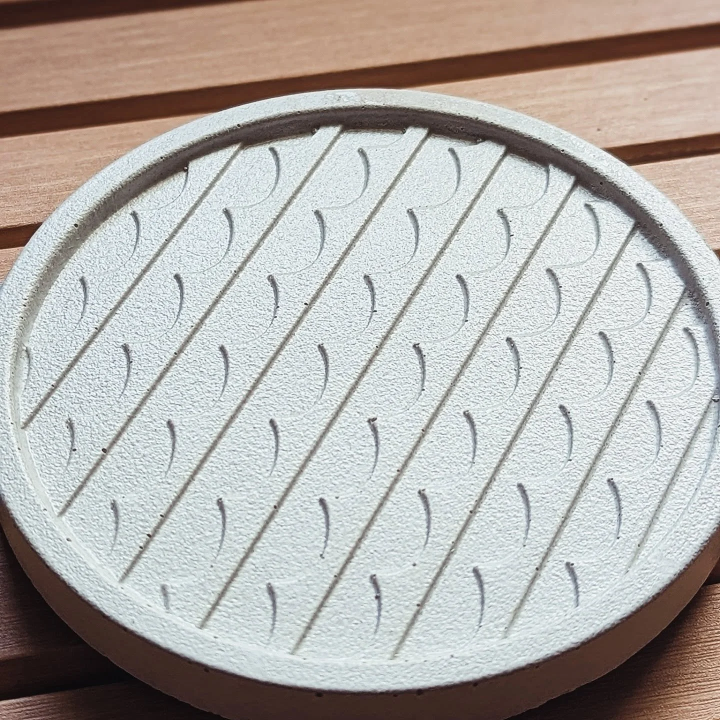 Castings out of our newest coaster molds. Happy we were able to make some improvements here. This new color, "porcelain", is trying its best to mimic PANTONE&reg; 11-4201 TCX (Cloud Dancer). 

If you look close enough youll notice a slight 