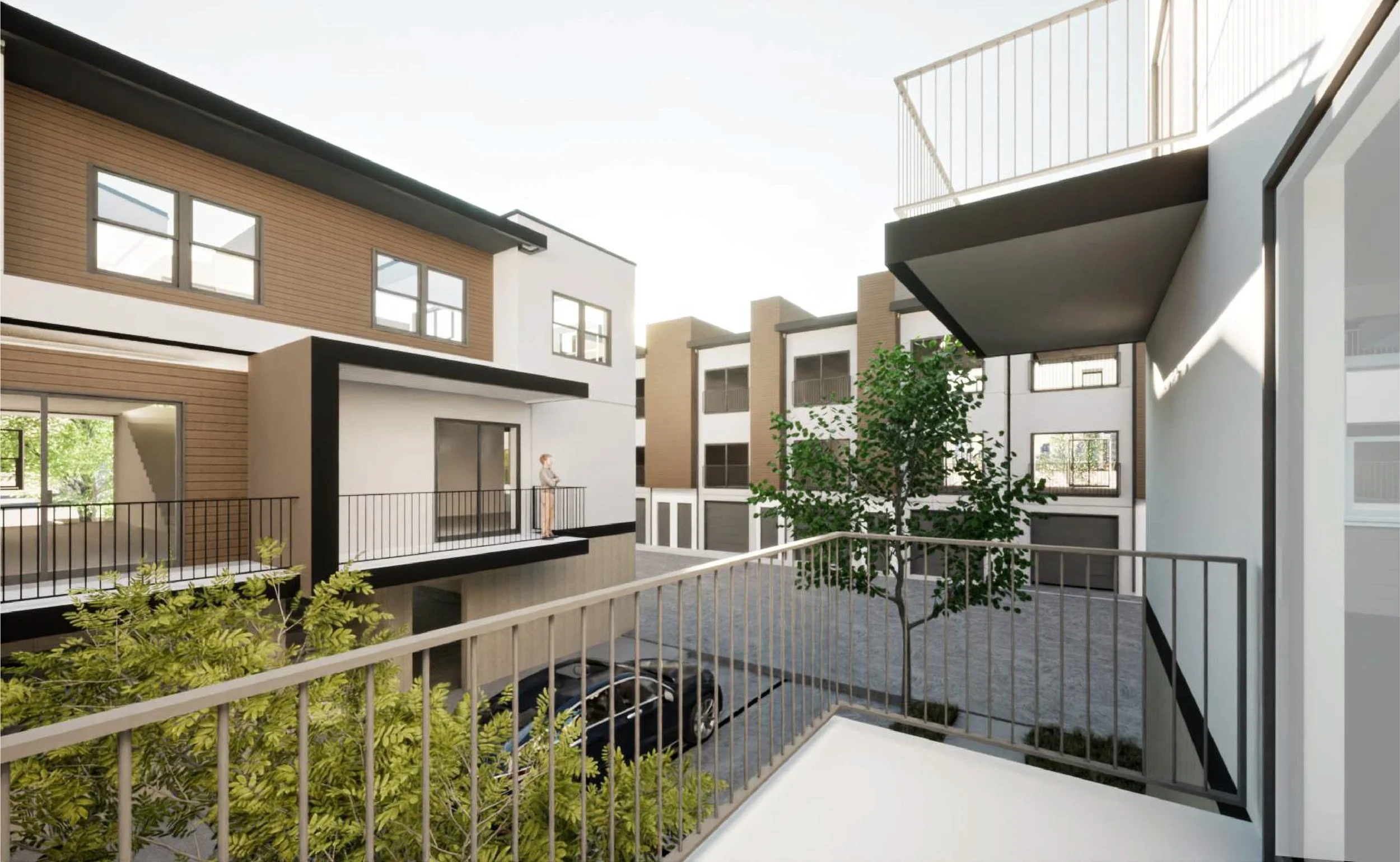 Modern apartment complex courtyard with balconies, trees, and parked cars, showing multiple multi-story buildings with glass windows and sliding doors.