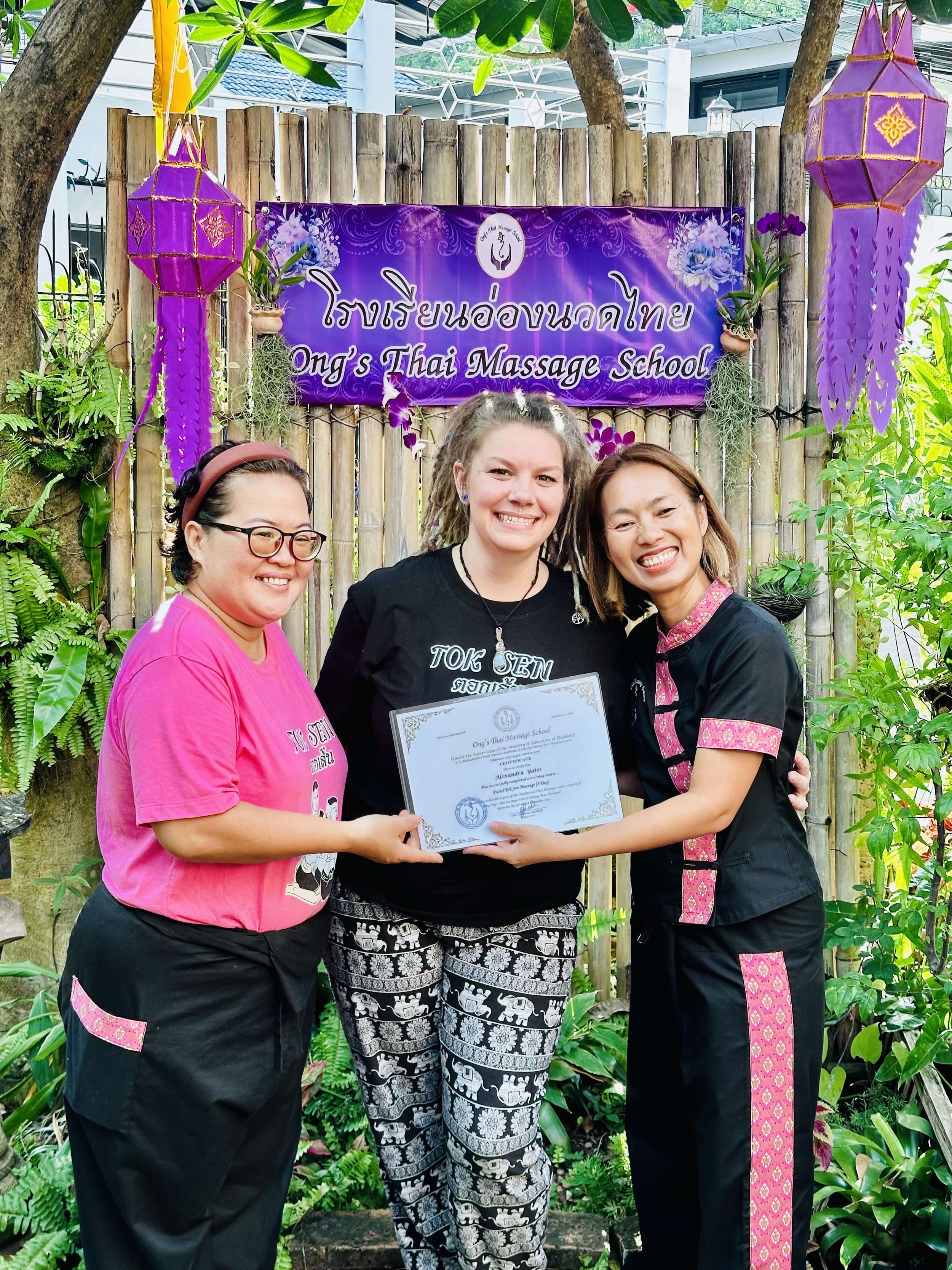 Jade receiving a certificate after completing a Thai Massage class at 'Ong's Thai Massage School in Chiang Mai, Thailand on a study abroad trip in 2024.