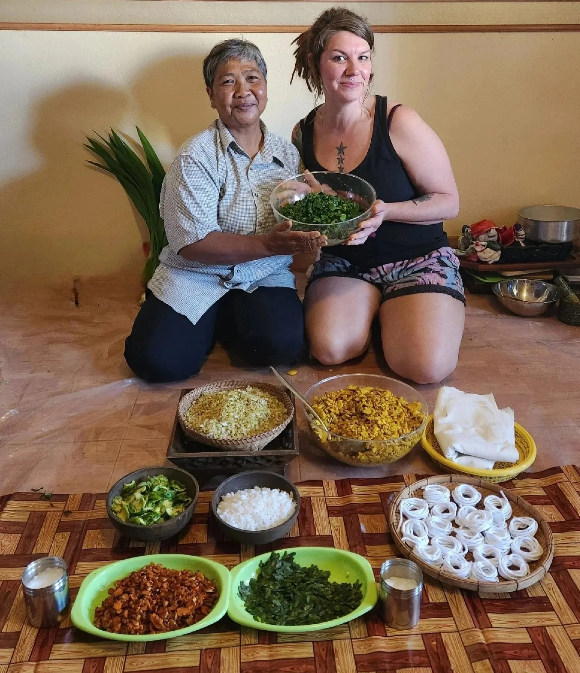 Thai Herbal Compress class on a study abroad trip to Thailand in 2023. All the herbs laid out in front of the teacher and student.