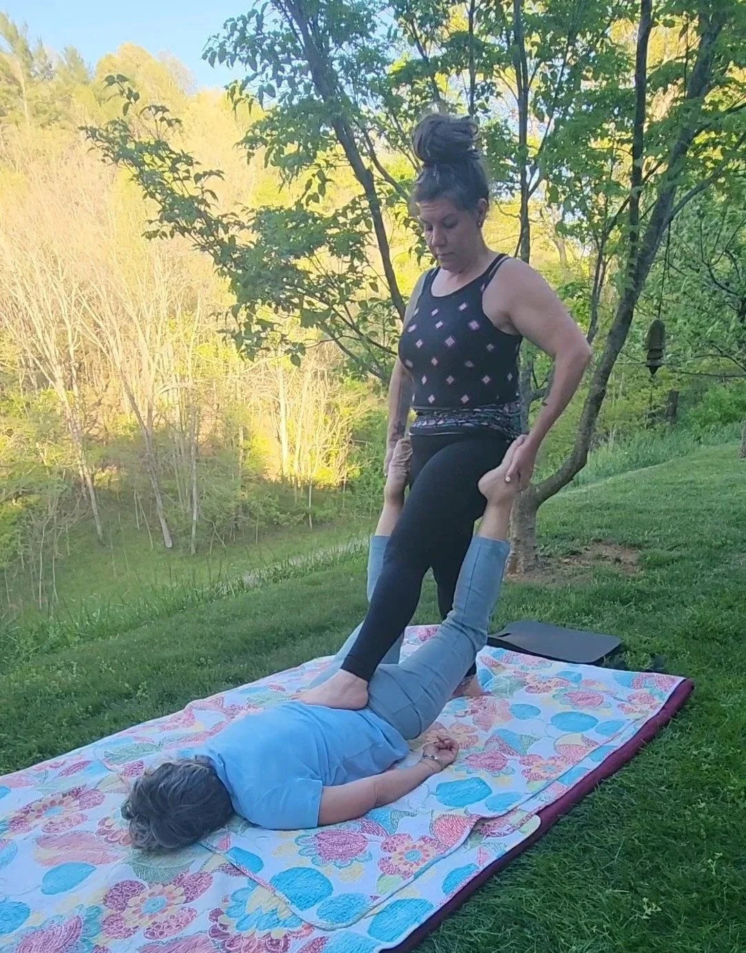 Thai Massage stretches outside in nature.