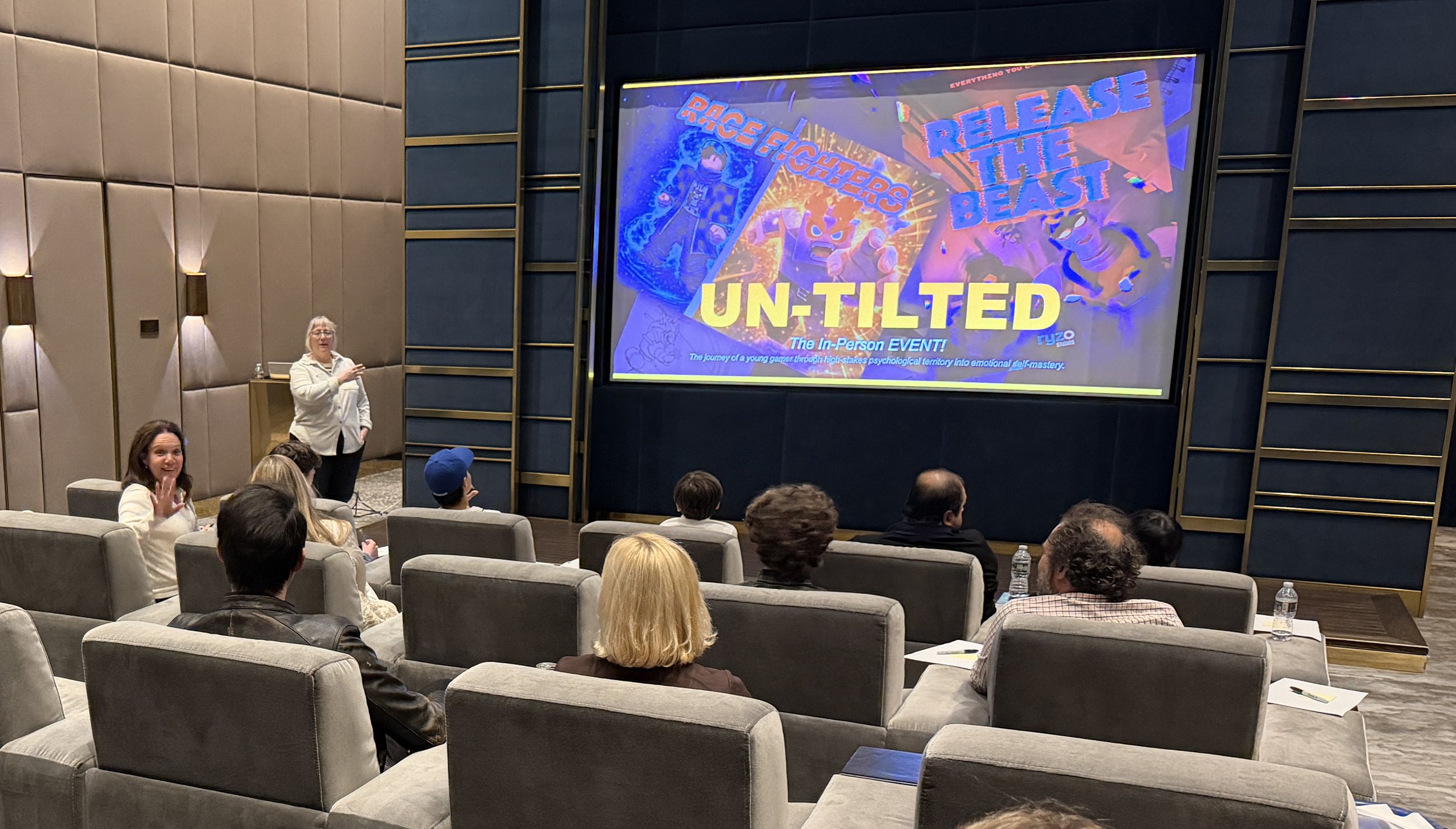 Image of people in theater watching Un-Tilted presentation on movie screen