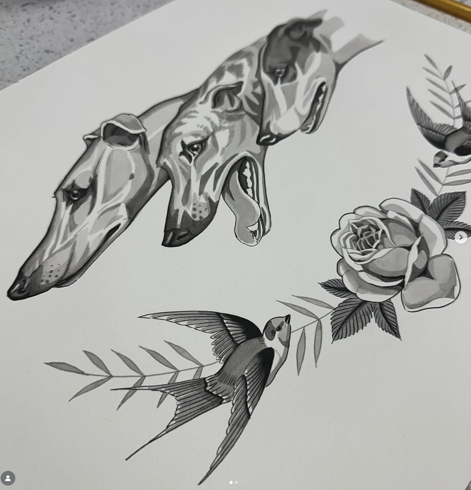 A black and gray tattoo-style drawing of three dog heads, a rose, a bird, and leaves on white paper.