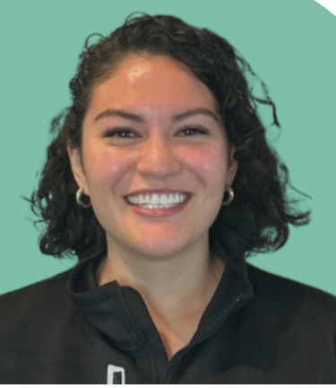 A woman with medium skin, curly dark hair, and silver hoop earrings smiling against a split teal and white background.